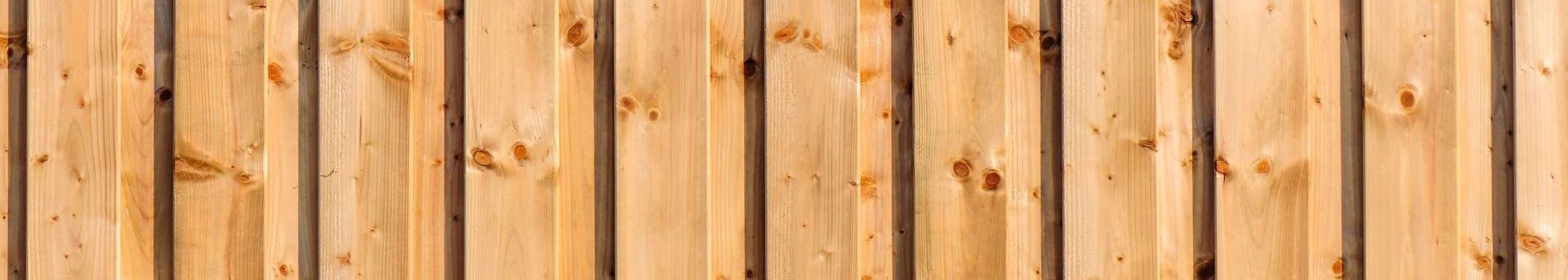 Wooden planks arranged vertically, with natural grain and knots.