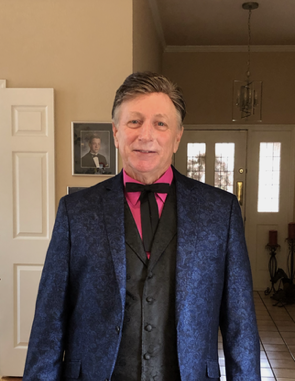 A man in a suit and tie is standing in a hallway