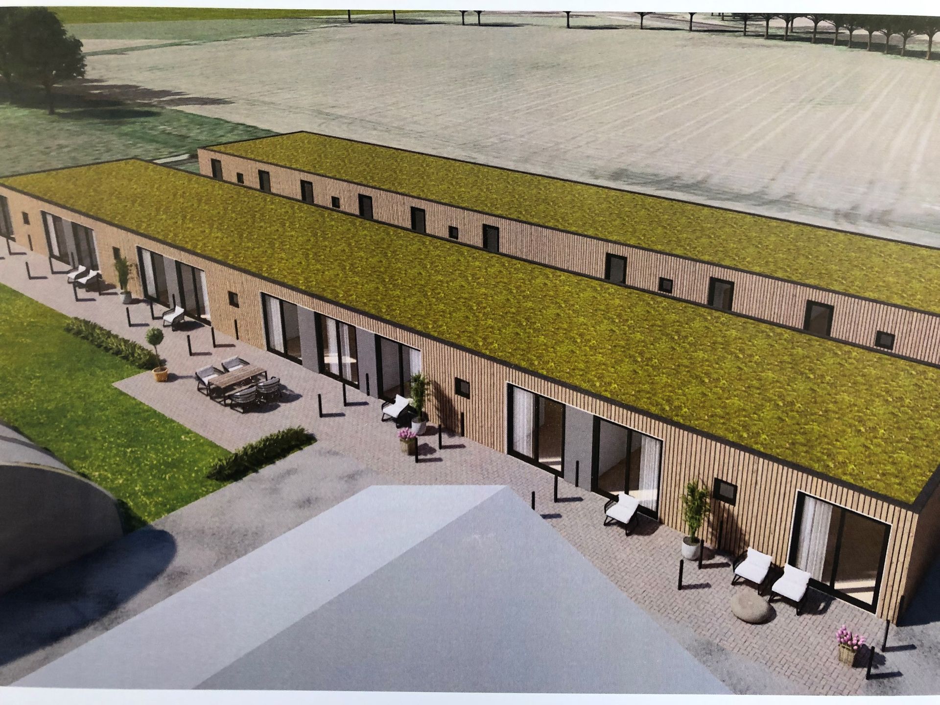 Een luchtfoto van een gebouw met een groen dak