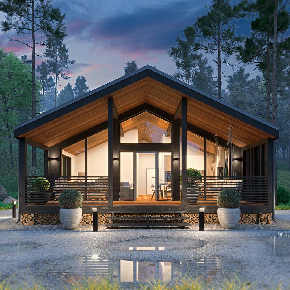 Een huis met veel ramen is omgeven door bomen