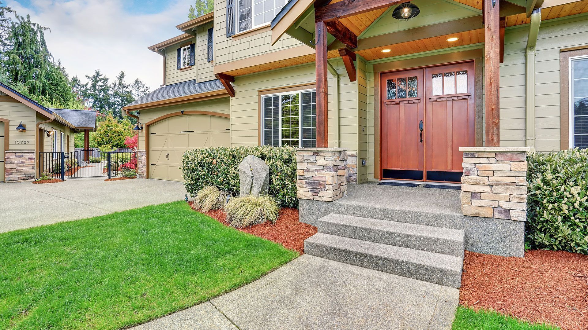 Exterior With Column Porch And Stone Wall