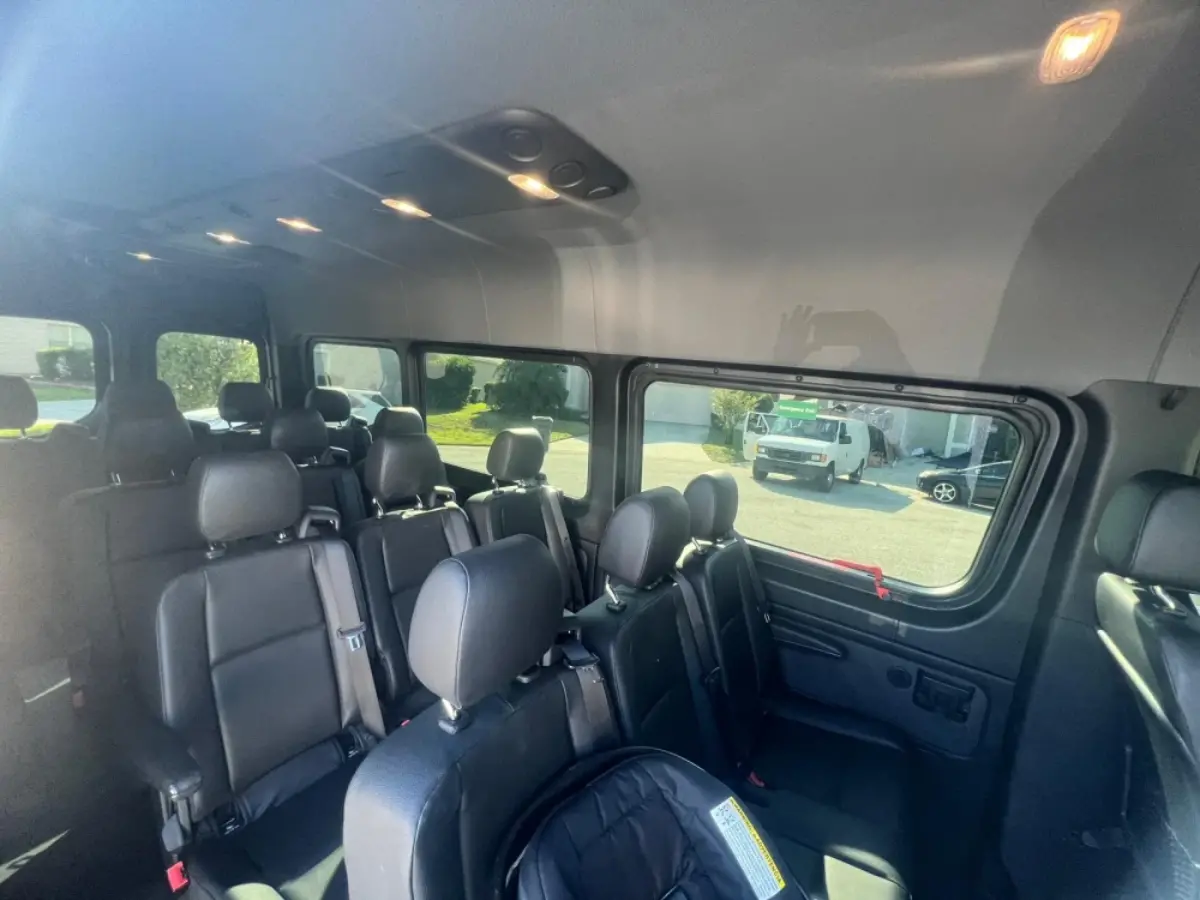 The inside of a van with a lot of seats and a lot of windows.