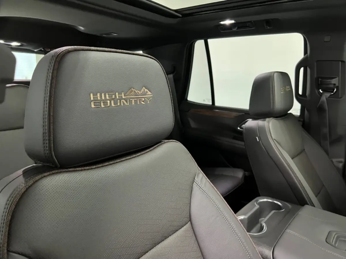 The headrest of a car with the word high country embroidered on it