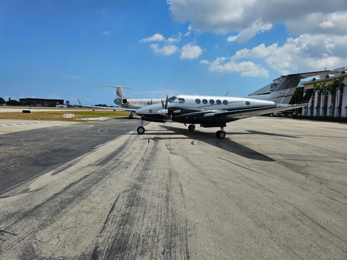 A small plane is parked on the runway of an airport