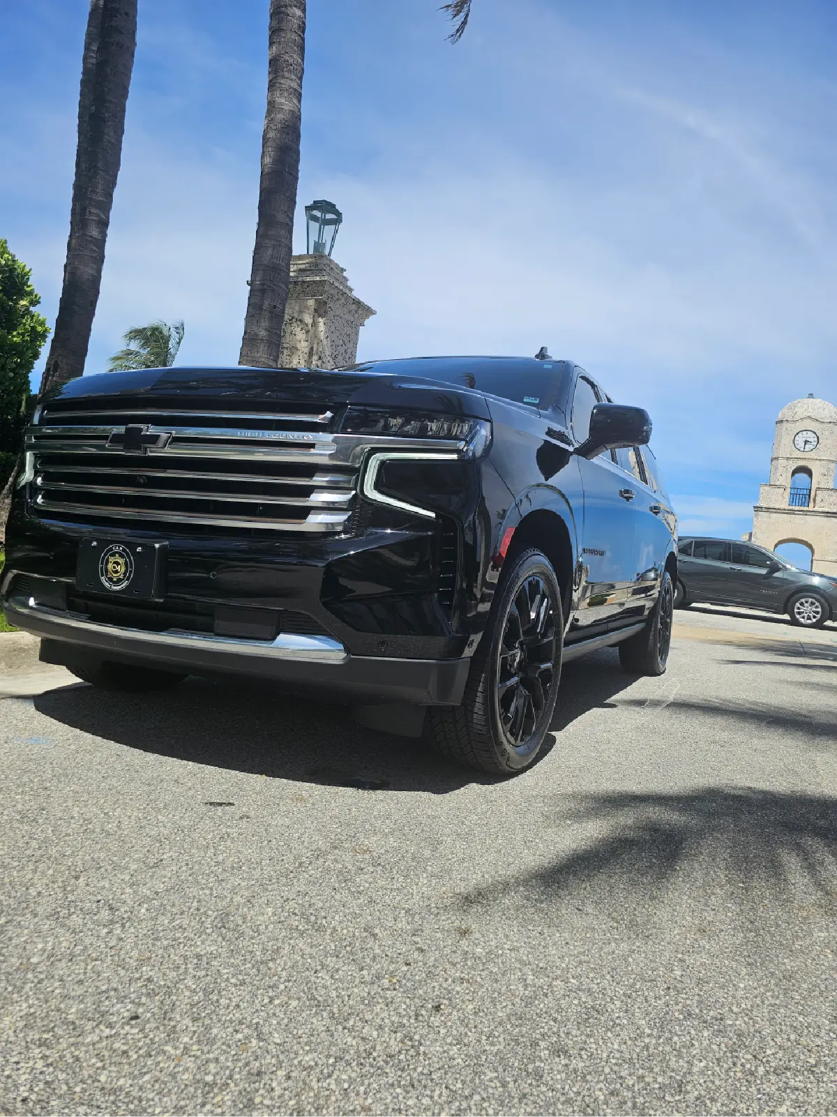A black suv is parked on the side of the road.