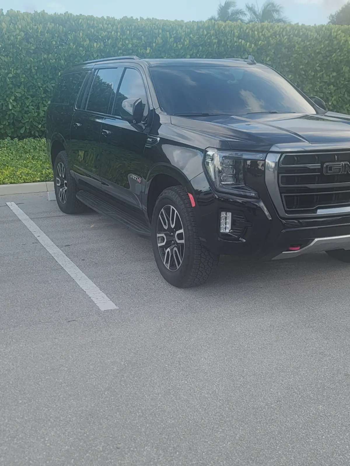 A black suv is parked in a parking lot.