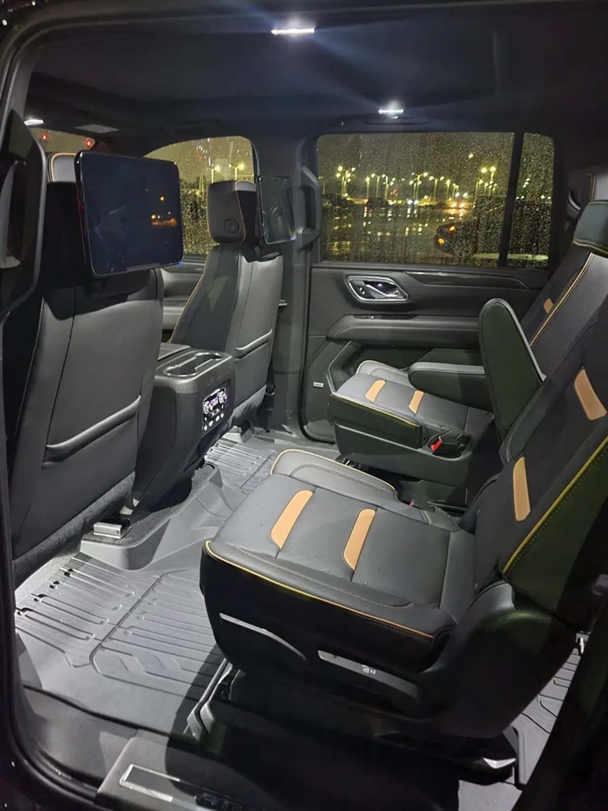 The interior of a chevrolet suburban is shown at night.