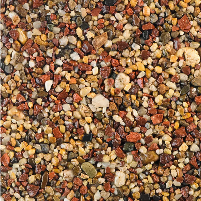 Close-up of a multi-colored aggregate, featuring red, brown, yellow, and beige pebbles.