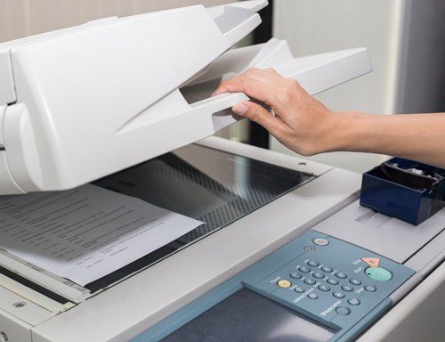Woman Opening a Photocopier — Miami, FL — Best Office Systems International Corporation