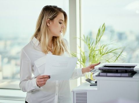 Businesswoman Prints on The Printer — Miami, FL — Best Office Systems International Corporation