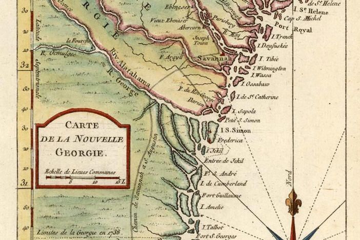 A man is giving a boy a piggyback ride while sitting on a couch.