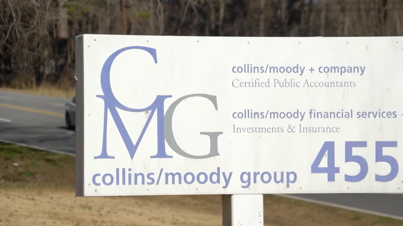 A woman in a hat is holding a little girl in her arms.