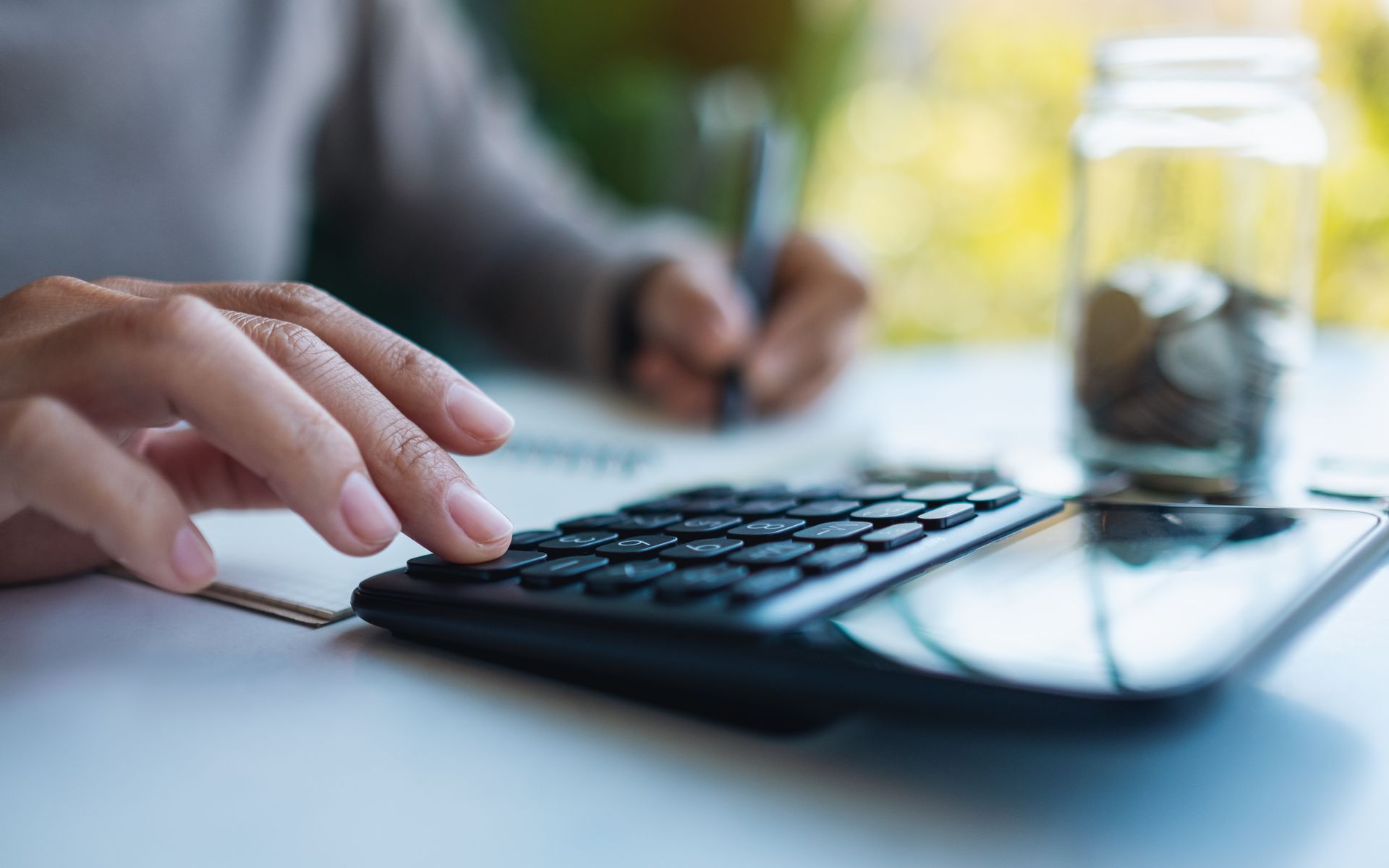 A young boy is sitting in the driver 's seat of a convertible car.