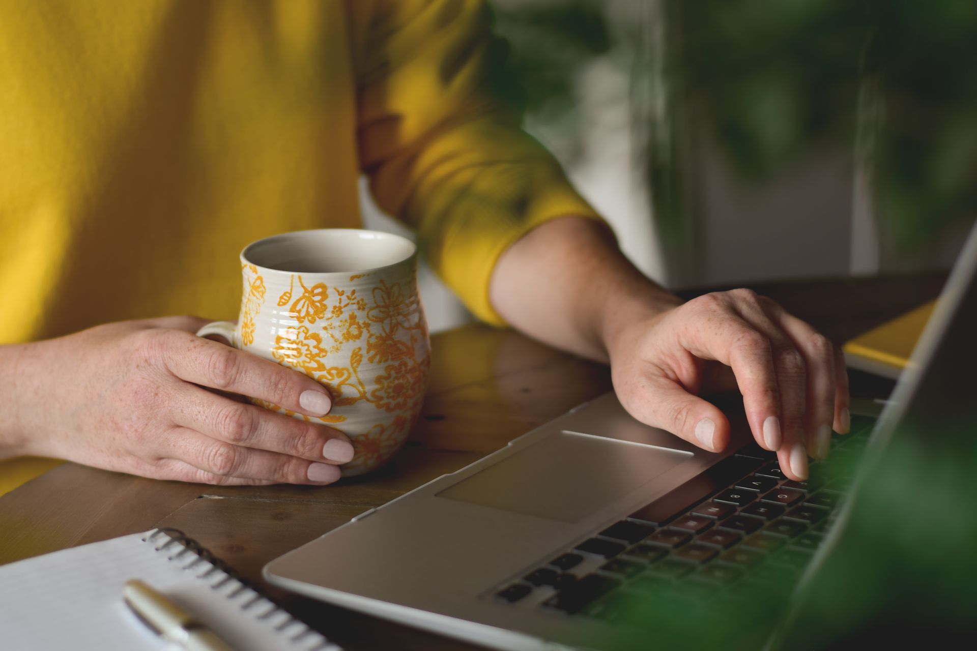A young boy is sitting in the driver 's seat of a convertible car.