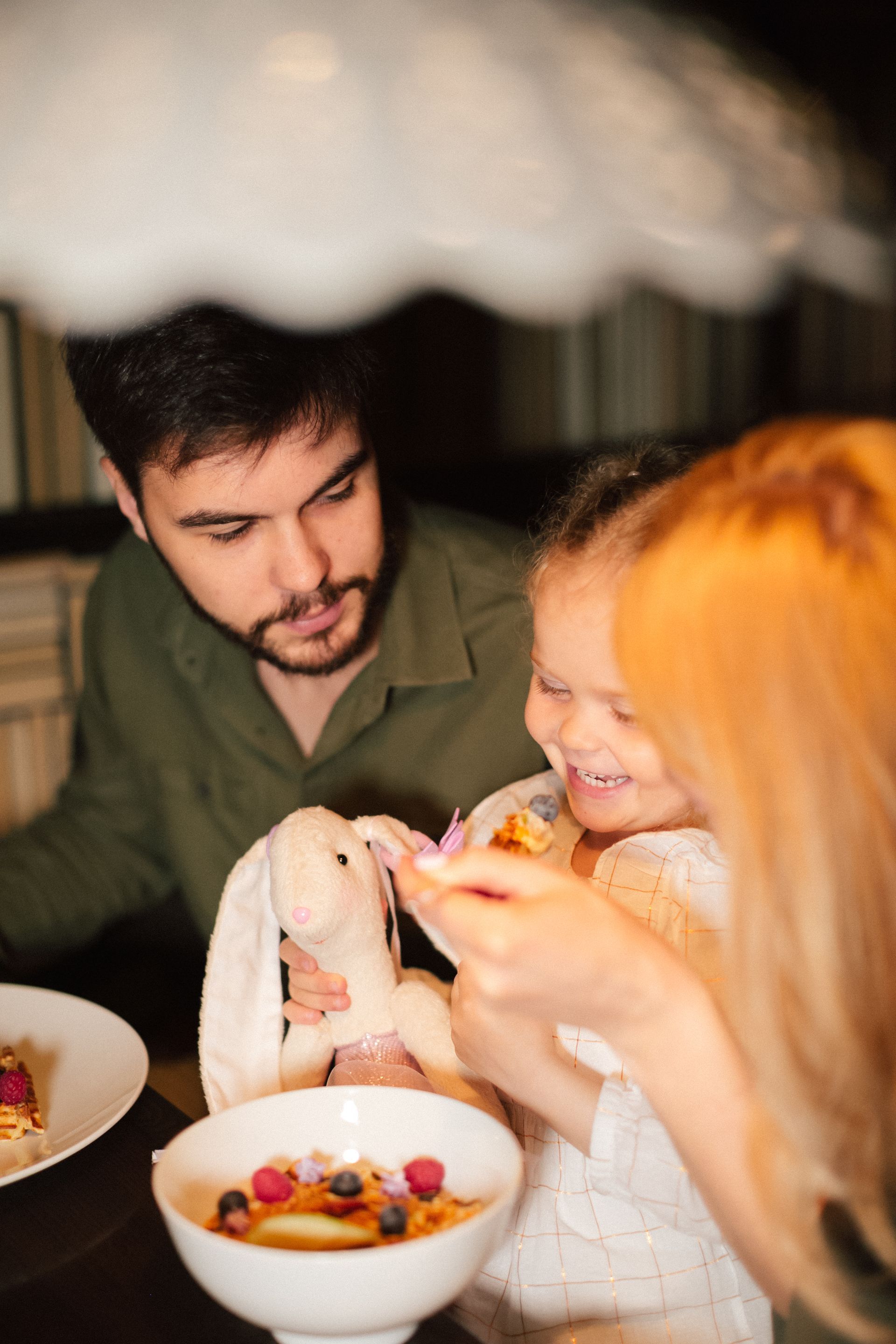 A young boy is sitting in the driver 's seat of a convertible car.