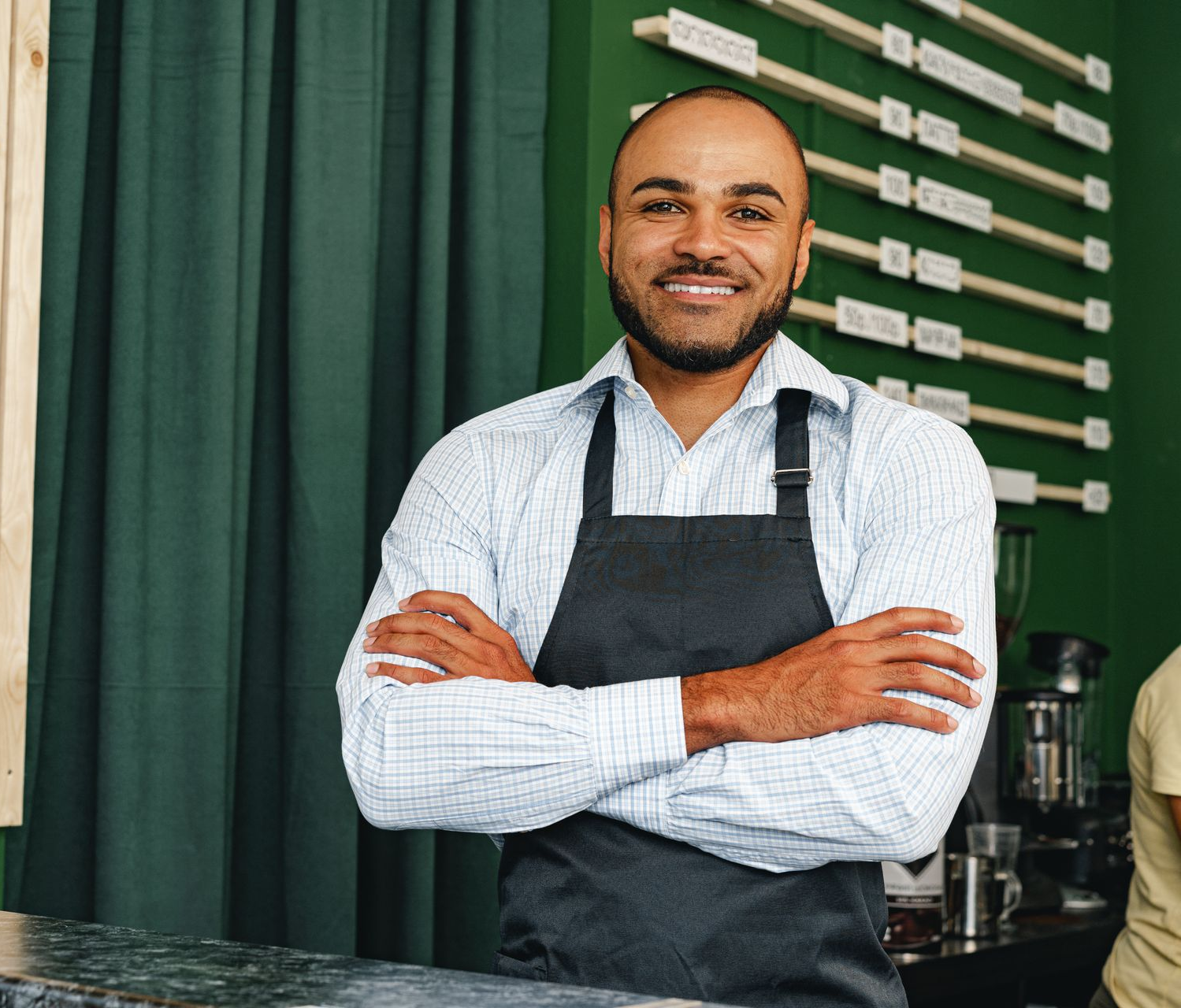 A young boy is sitting in the driver 's seat of a convertible car.