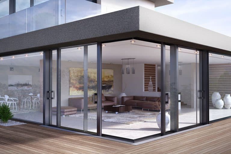 A large house with a lot of windows and sliding glass doors.