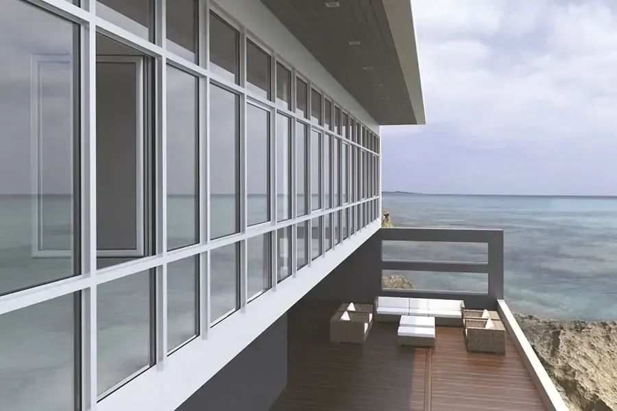A large building with a balcony overlooking the ocean