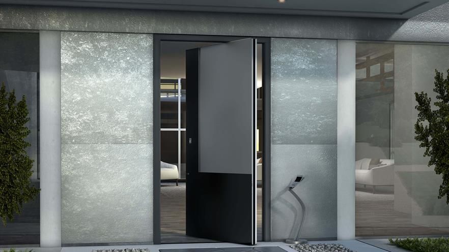 A large door is open to a living room with a statue in front of it.