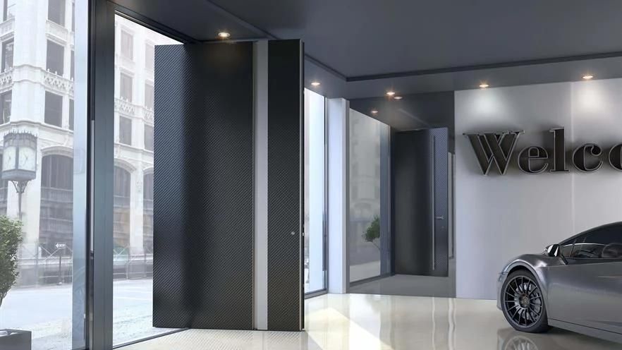 A car is parked in a room with a sign that says welco.