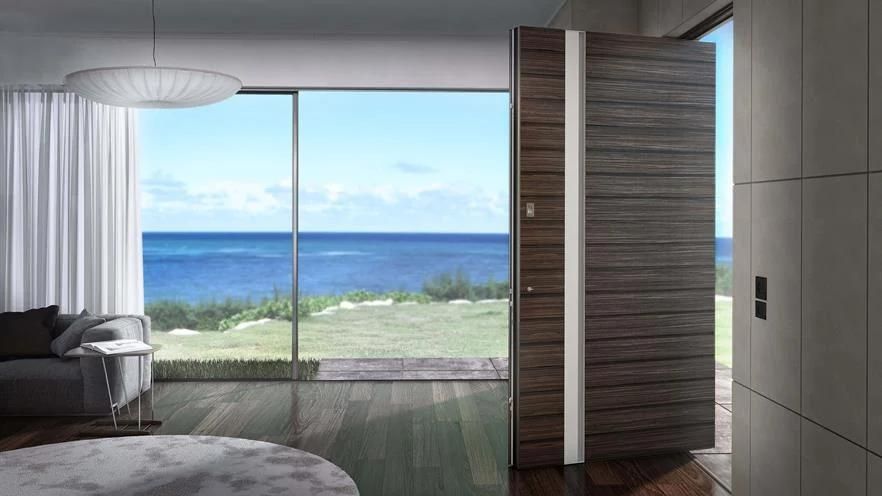 A living room with a large window overlooking the ocean.