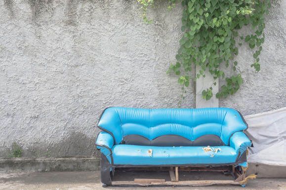 couch with used items on it