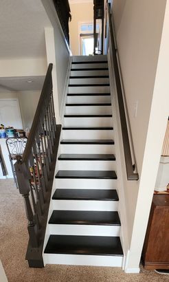 A house with brand new black and white interior staircase.