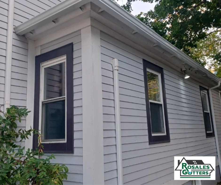 A white house with black trim and gutters from ronald gutters