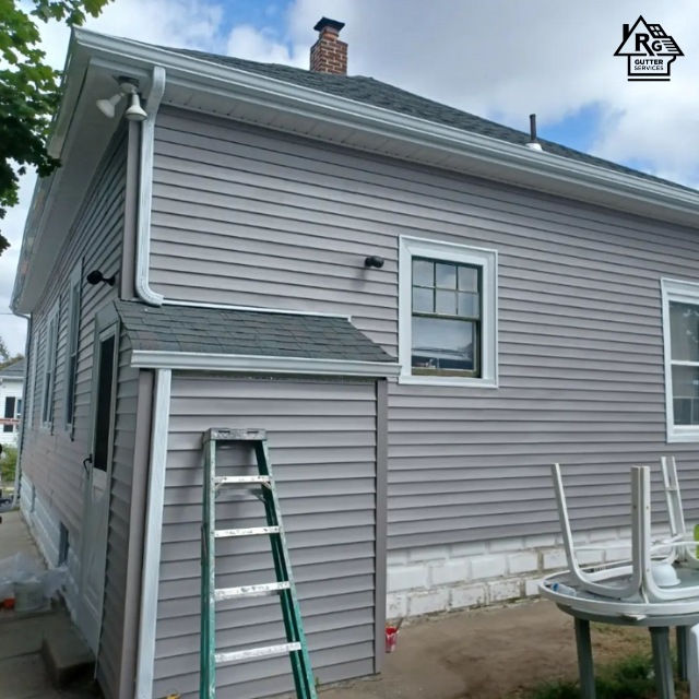 A ladder is leaning against the side of a house