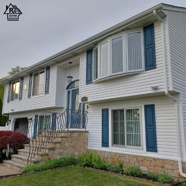 A white house with blue shutters and stairs
