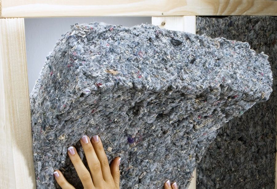 A man is working on a kitchen in a house under construction