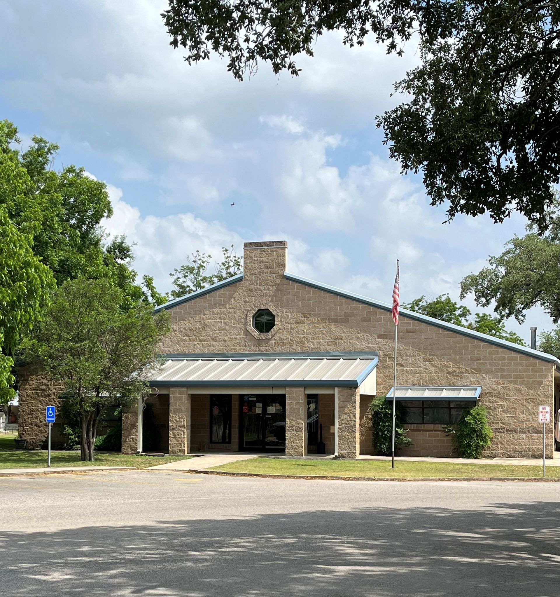 A large brick building with a flag in front of it