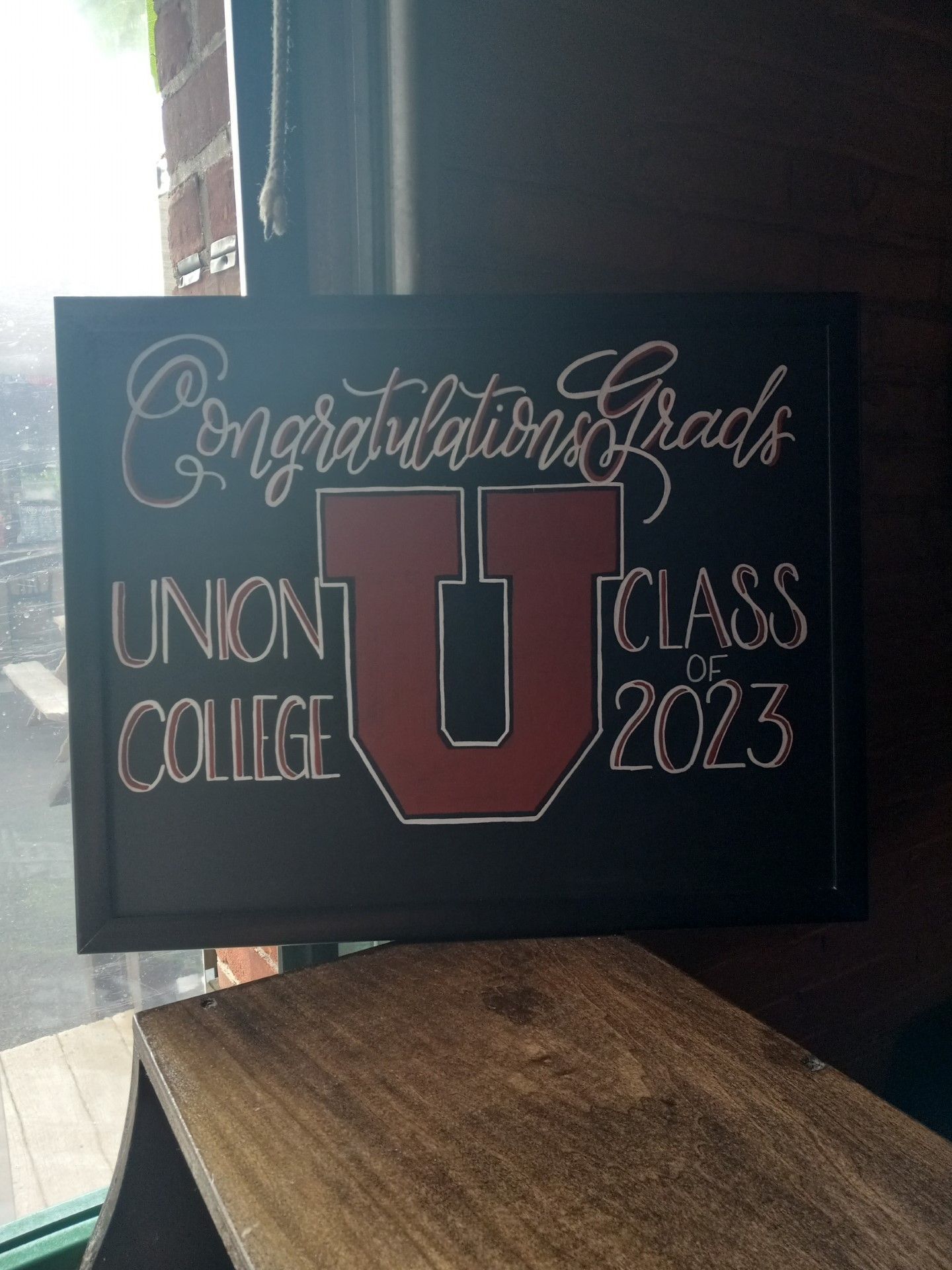 “Congratulations Grads” Union College Class of 2023 sign with large red U on a black background
