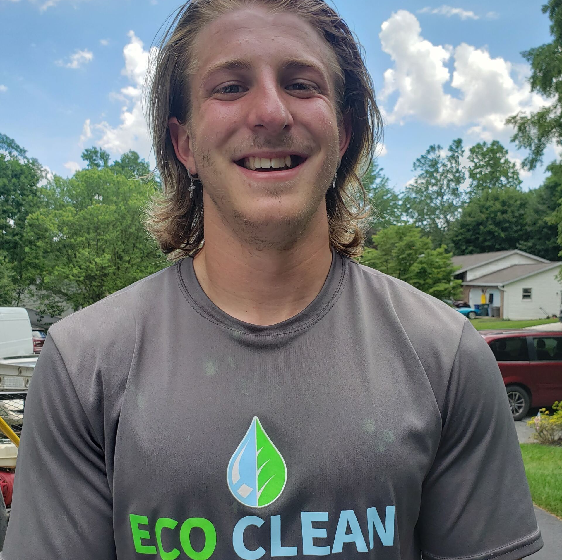 A man wearing an eco clean shirt smiles for the camera