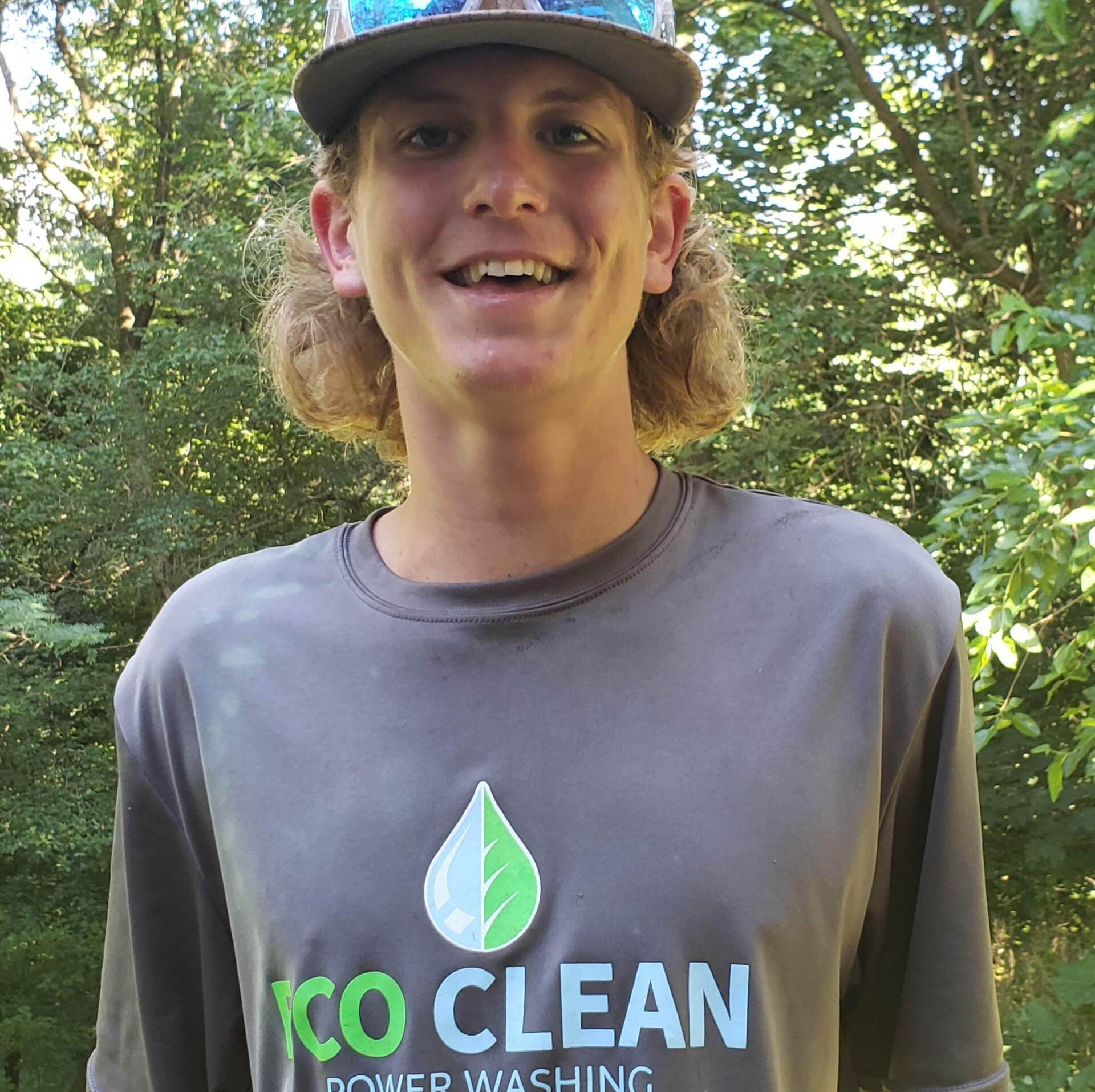 A man wearing a hat and a shirt that says 