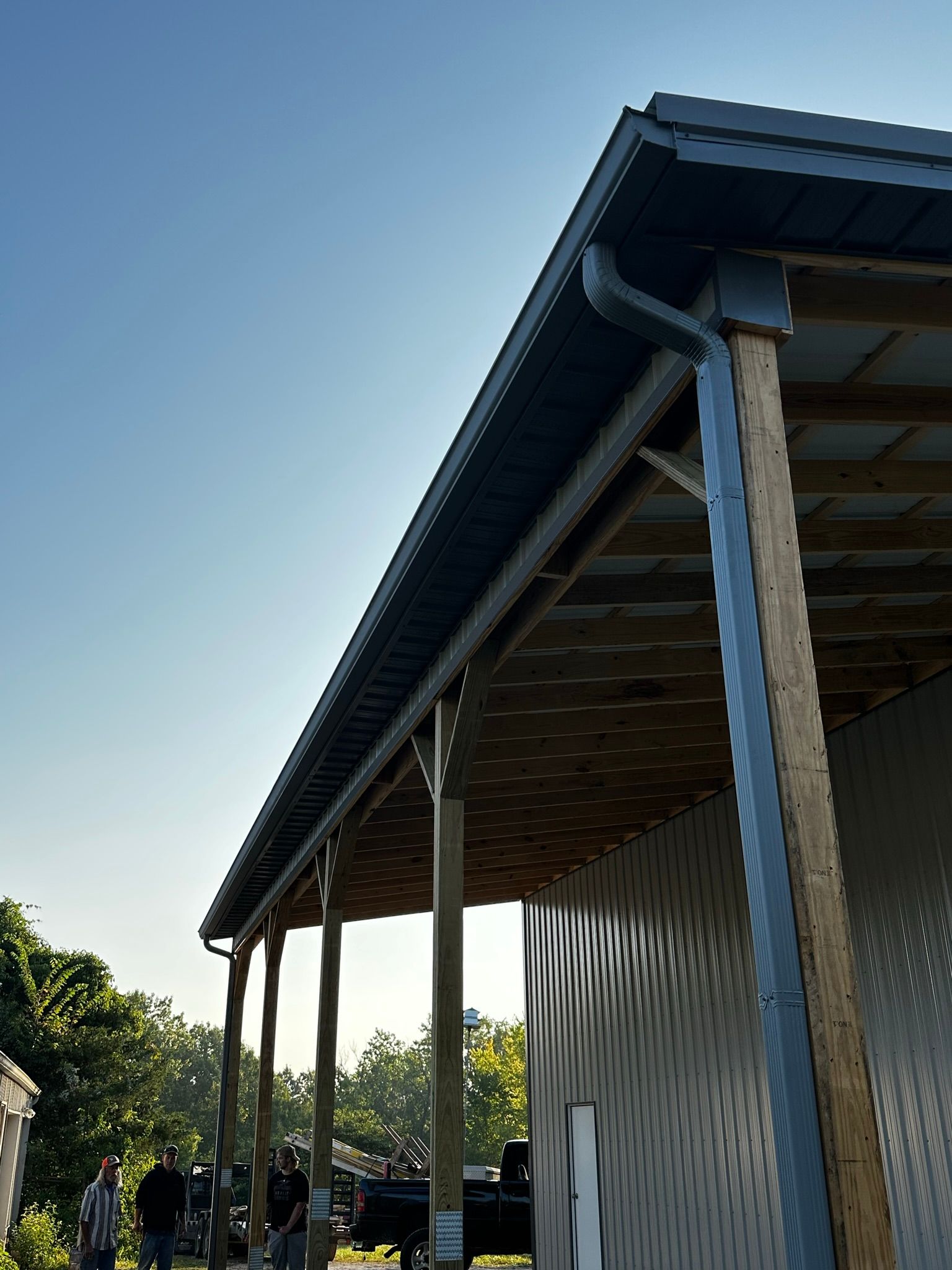 a group of people standing outside of a building with a blue sky in the background