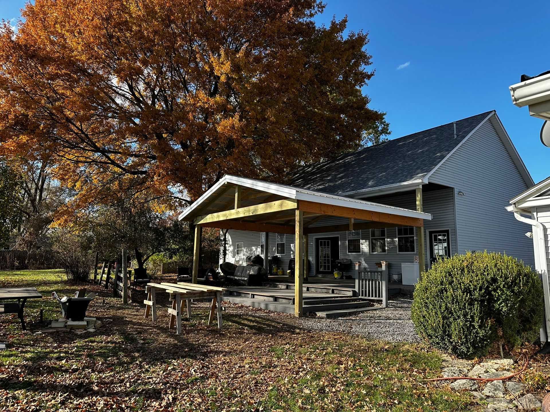 a white house with a picnic area in front of it
