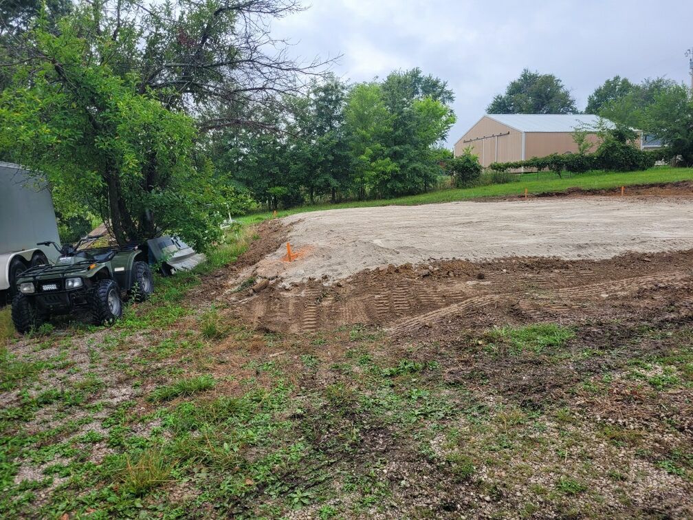 a atv is parked in the middle of a dirt field .