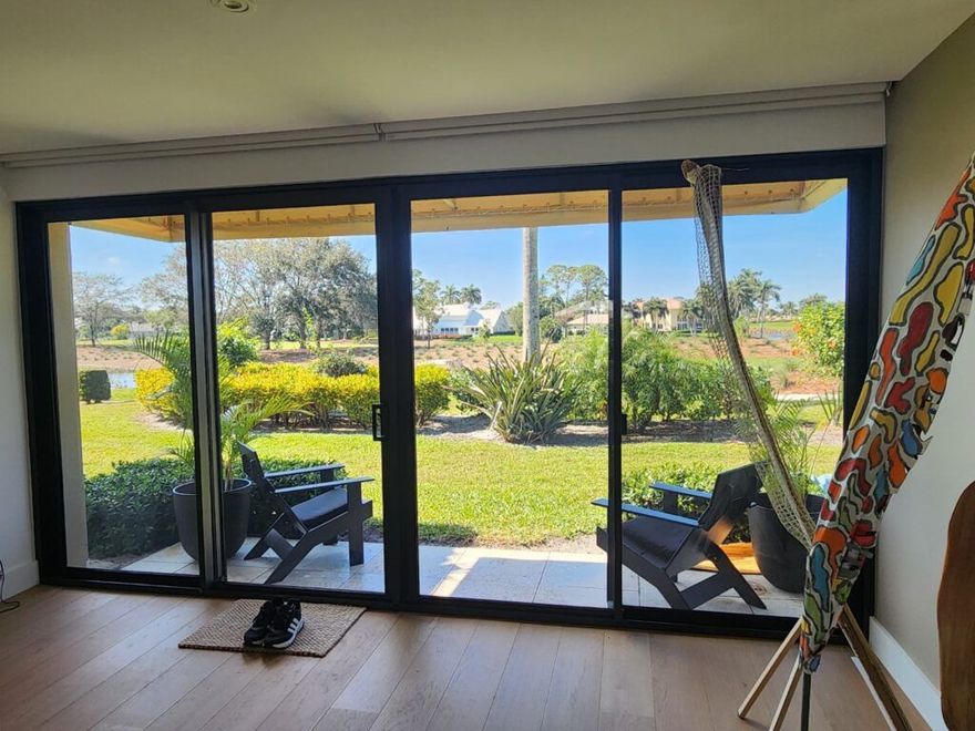 A living room with a sliding glass door leading to a patio.