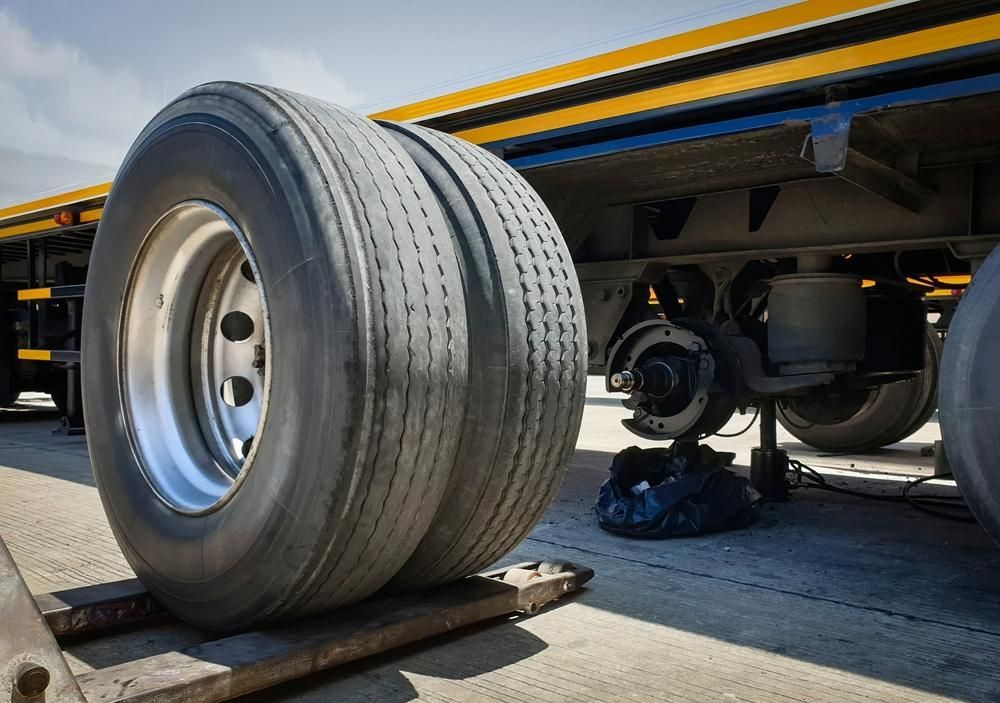 Two Tires Are Stacked on Top of Each Other on A Truck — Petersen's Second Hand & New Tyres in Currajong, QLD