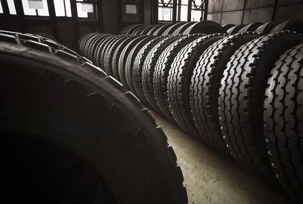 A Warehouse Filled with Lots of Tires Stacked on Top of Each Other — Petersen's Second Hand & New Tyres in Currajong, QLD