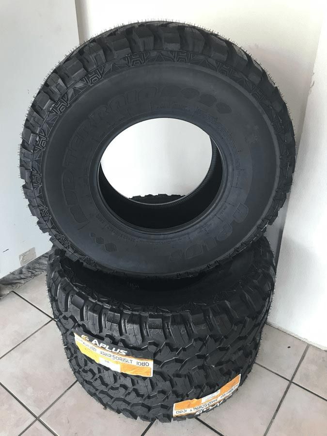 Two Tires Are Stacked on Top of Each Other on A Tiled Floor — Petersen's Second Hand & New Tyres in Currajong, QLD