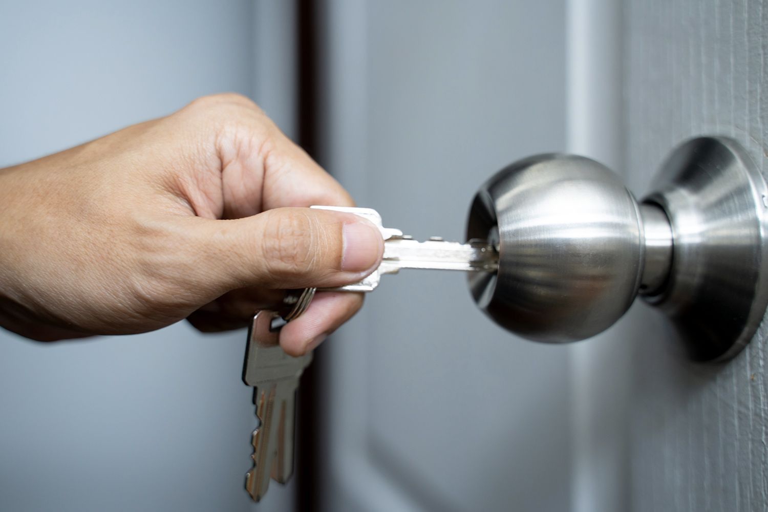 Person Opening a Door — Boise, ID — Baldwin Lock & Key