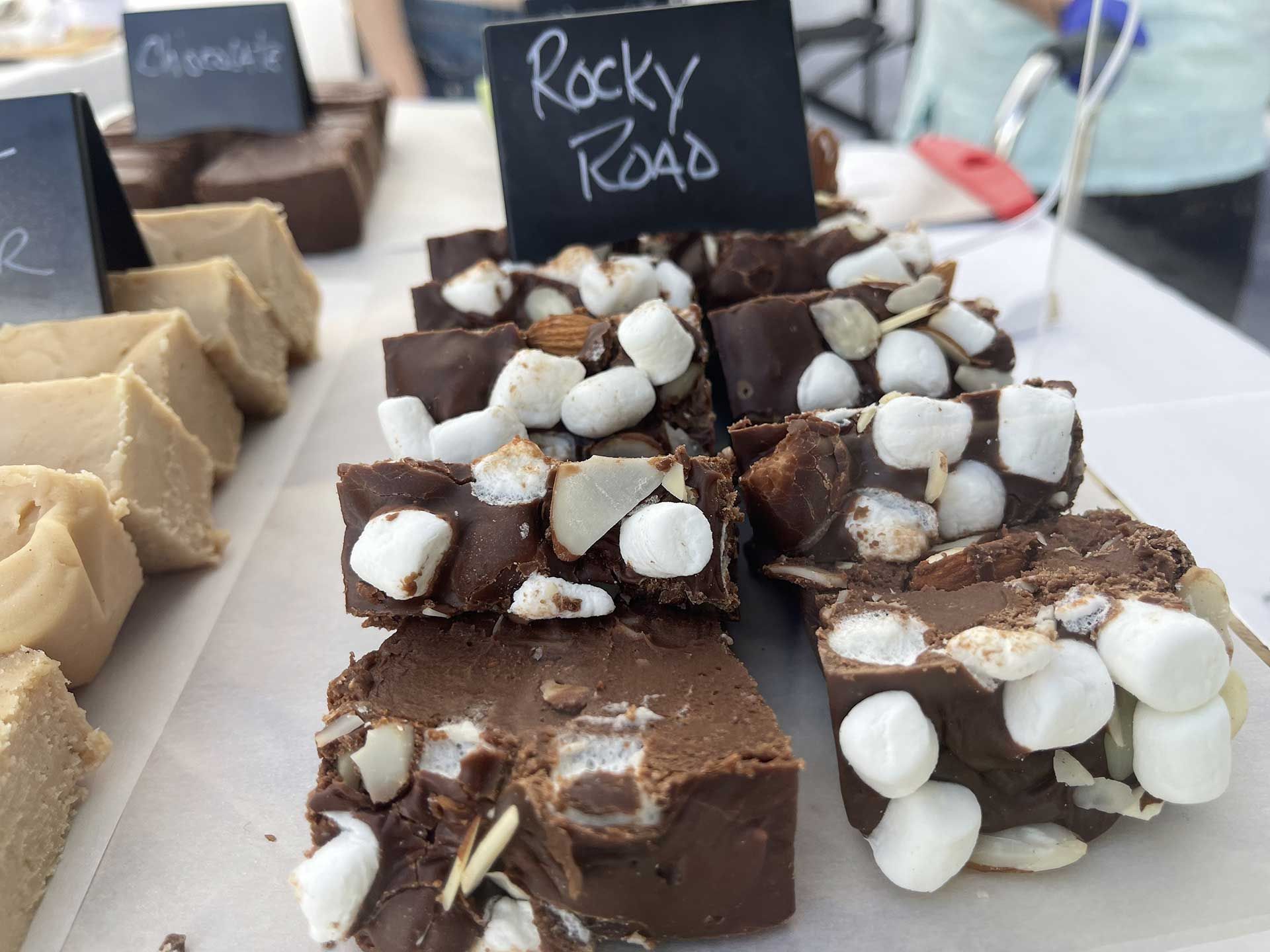 Close-up of Rocky Road fudge with marshmallows and almonds at a market stall.