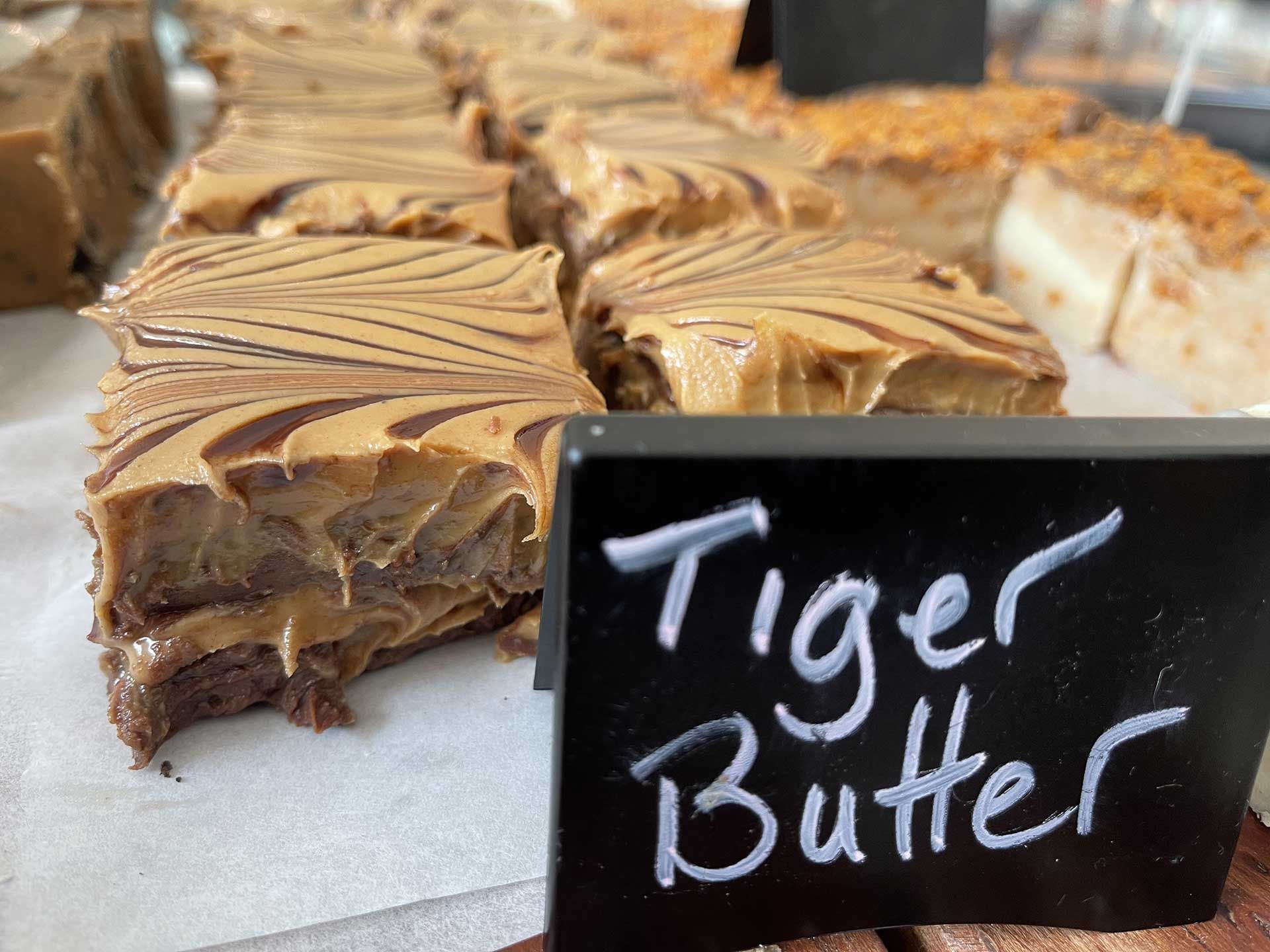 Tiger Butter brownies with swirled peanut butter and a sign.