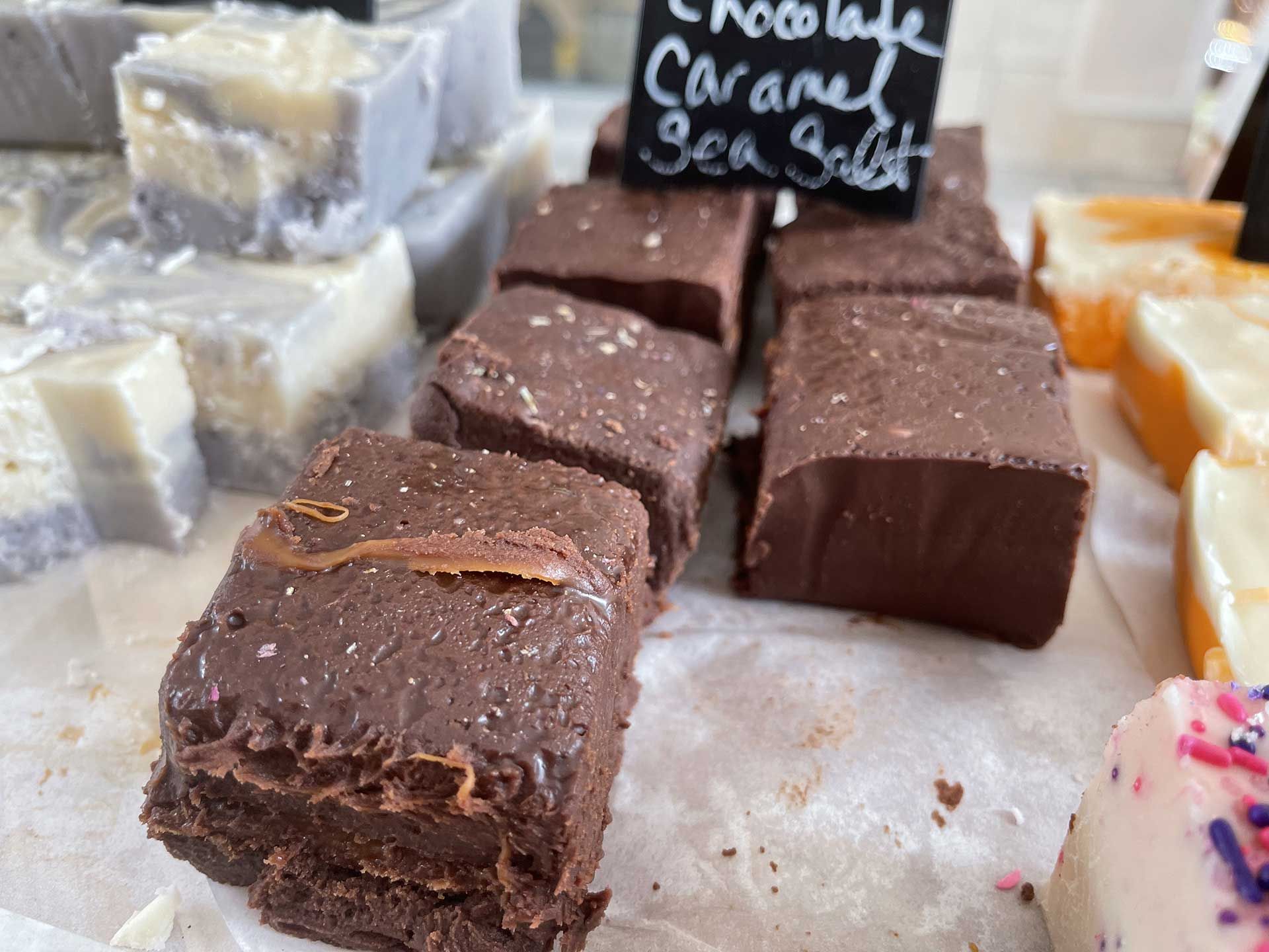 Chocolate caramel sea salt fudge squares on display.