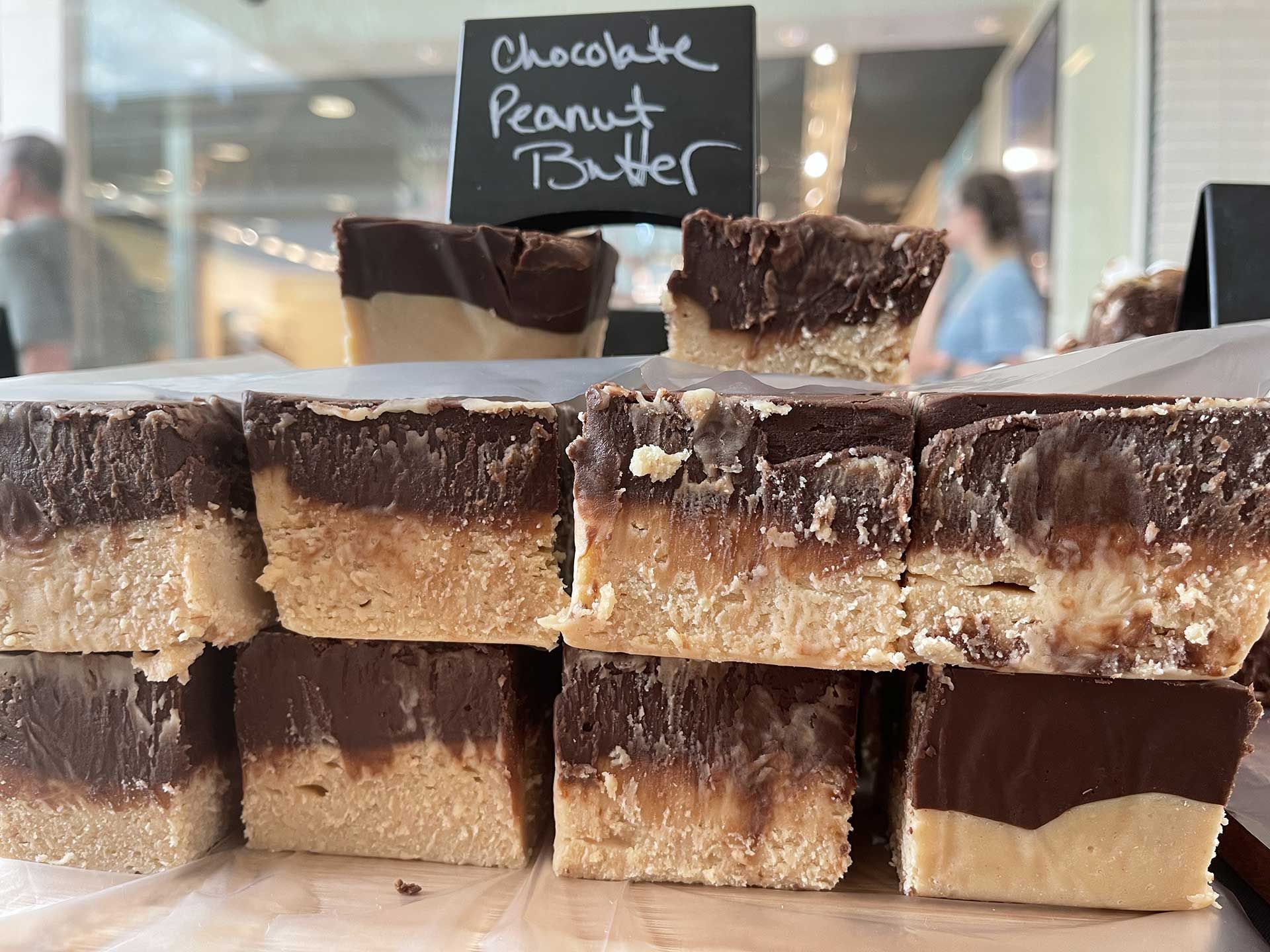 Chocolate peanut butter fudge, layered and stacked for sale.