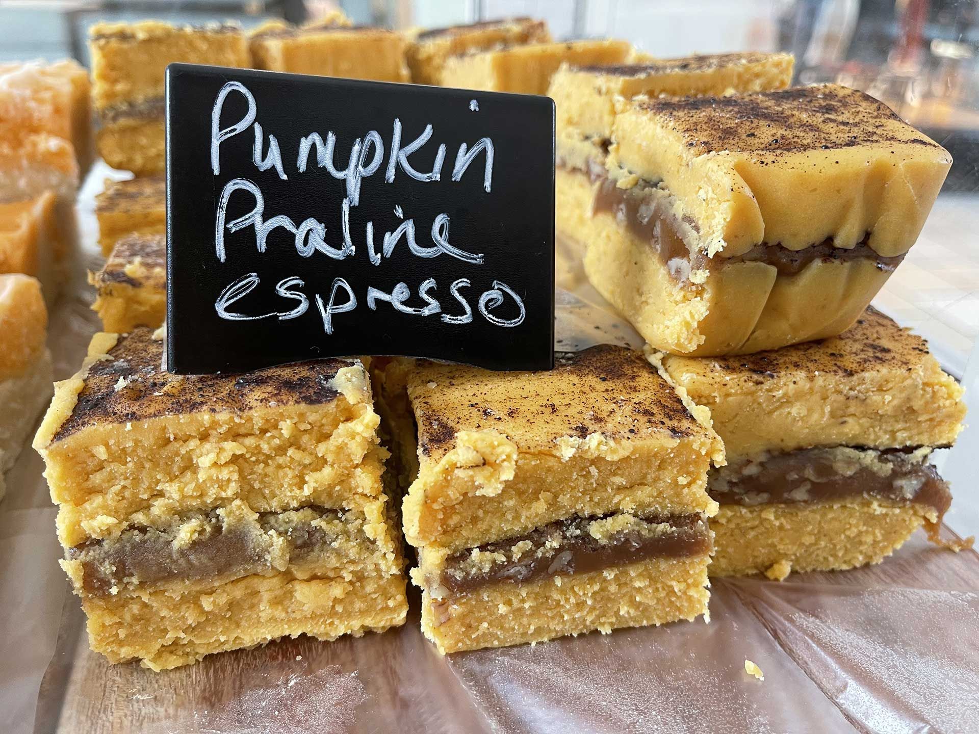 Pumpkin praline and espresso dessert squares with a sign.
