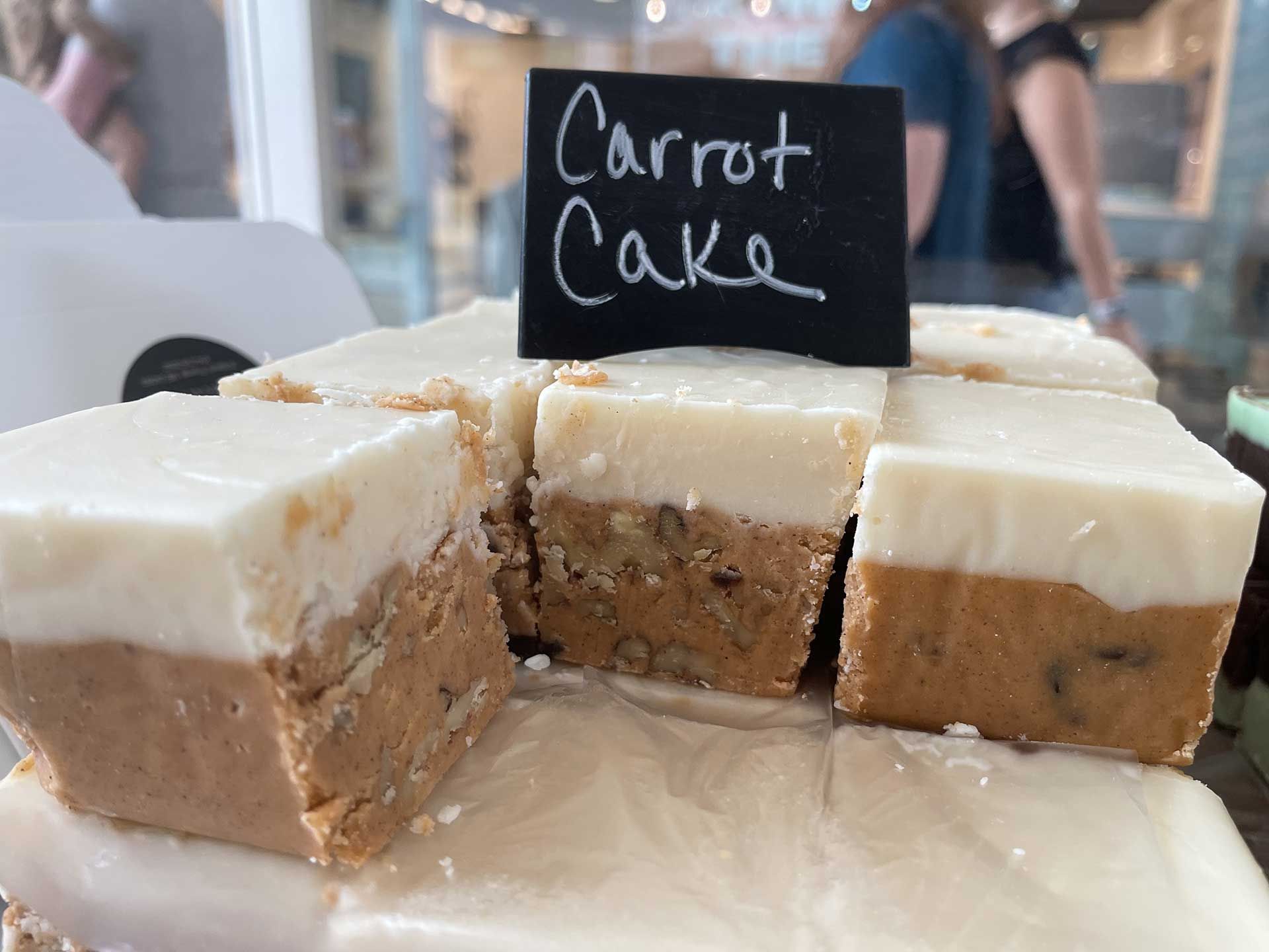 Carrot cake squares with white frosting, topped with a