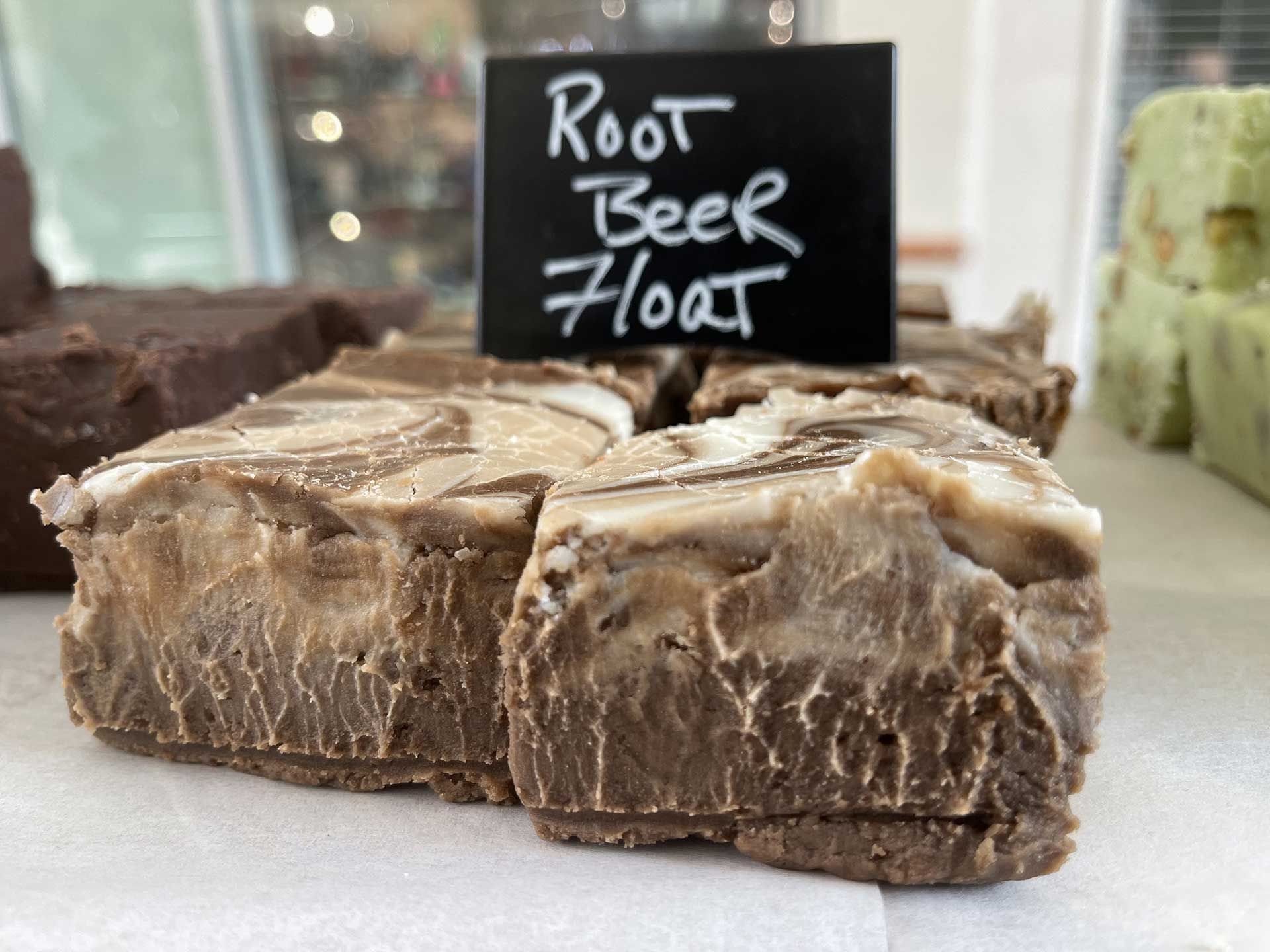 Root beer float fudge with a handwritten sign on a white surface.